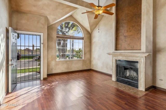 unfurnished living room featuring a fireplace, dark wood-type flooring, ceiling fan, and lofted ceiling