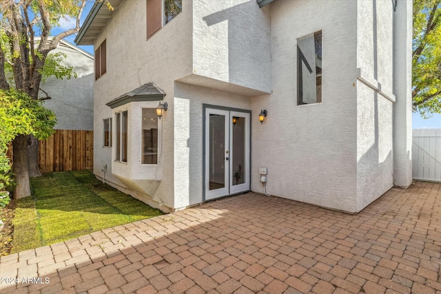 property entrance featuring a patio area and french doors