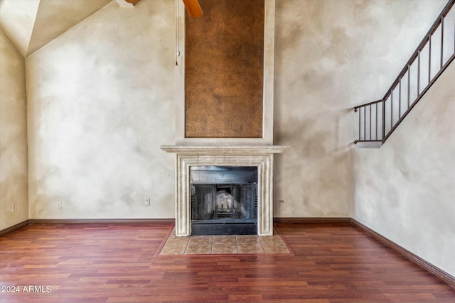 unfurnished living room with wood-type flooring and vaulted ceiling