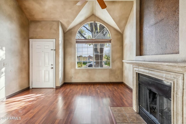 unfurnished living room with ceiling fan, dark wood-type flooring, a fireplace, and lofted ceiling