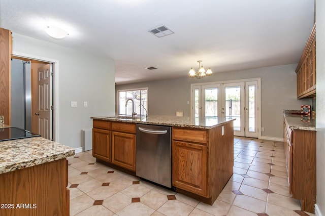 2338 E Javelina Ave, Mesa, AZ 85204 - kitchen with stainless steel appliances, brown cabinetry, a chandelier, and light stone countertops