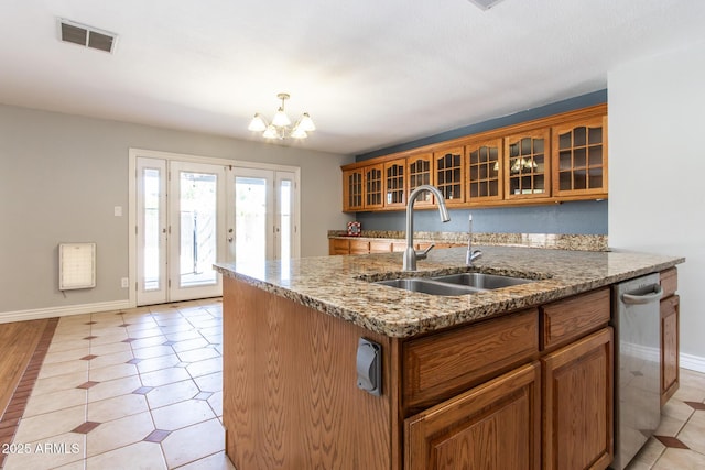 2338 E Javelina Ave, Mesa, AZ 85204 - kitchen featuring brown cabinets, glass insert cabinets, a chandelier, light stone counters, and dishwasher