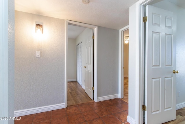 2338 E Javelina Ave, Mesa, AZ 85204 - corridor featuring tile patterned flooring, a textured ceiling, and a textured wall