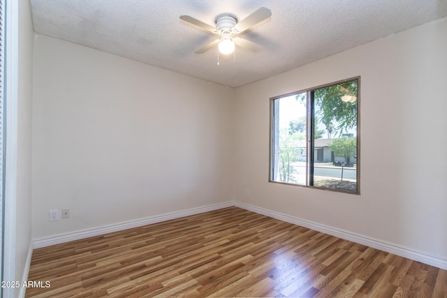 2338 E Javelina Ave, Mesa, AZ 85204 - spare room with wood finished floors, a textured ceiling, and a ceiling fan