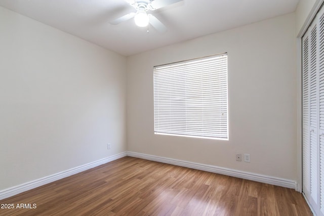 2338 E Javelina Ave, Mesa, AZ 85204 - unfurnished bedroom with wood finished floors, a closet, and a ceiling fan