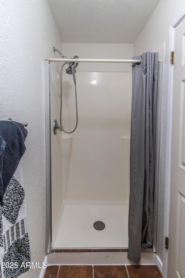 2338 E Javelina Ave, Mesa, AZ 85204 - bathroom with a shower stall, a textured ceiling, tile patterned flooring, and a textured wall