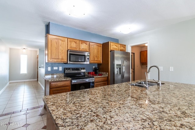 2338 E Javelina Ave, Mesa, AZ 85204 - kitchen with stainless steel appliances, light stone countertops, and light tile patterned floors