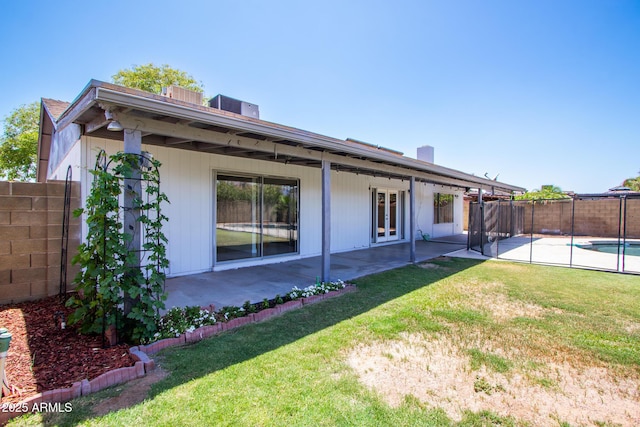 2338 E Javelina Ave, Mesa, AZ 85204 - rear view of house featuring a fenced backyard, a patio, a chimney, and french doors
