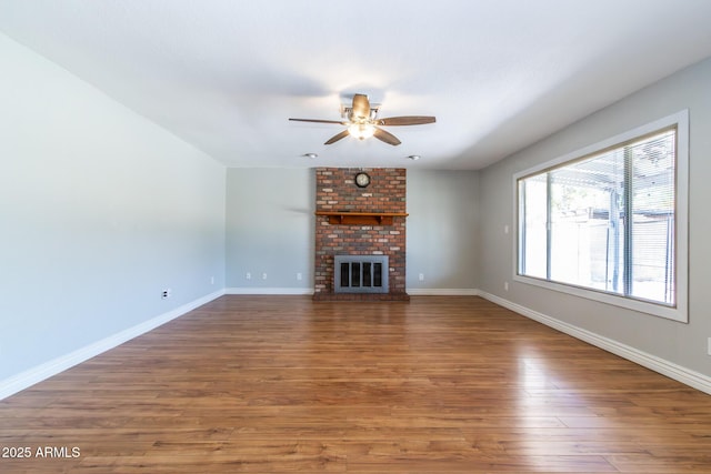 2338 E Javelina Ave, Mesa, AZ 85204 - unfurnished living room with ceiling fan, wood finished floors, and a brick fireplace