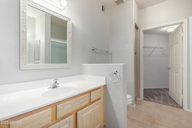 full bath with toilet, tile patterned flooring, visible vents, and vanity