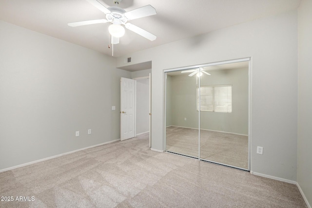 unfurnished bedroom featuring visible vents, a closet, a ceiling fan, and carpet flooring