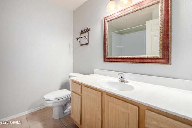 bathroom with vanity, toilet, and tile patterned floors