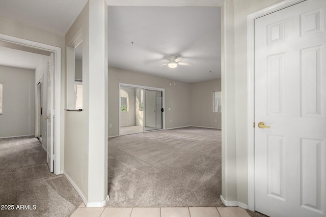 interior space with tile patterned flooring, carpet flooring, and baseboards