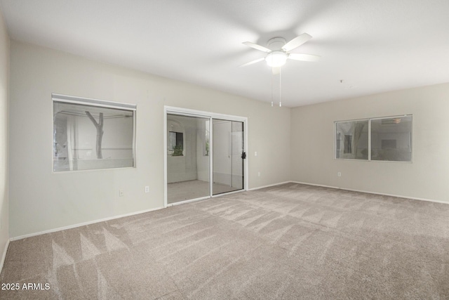 unfurnished bedroom featuring ceiling fan, a closet, carpet, and baseboards