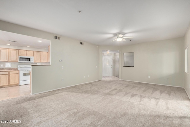 unfurnished living room featuring a ceiling fan, light colored carpet, visible vents, and recessed lighting