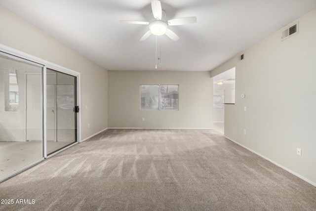 unfurnished bedroom featuring carpet floors, visible vents, baseboards, and a ceiling fan