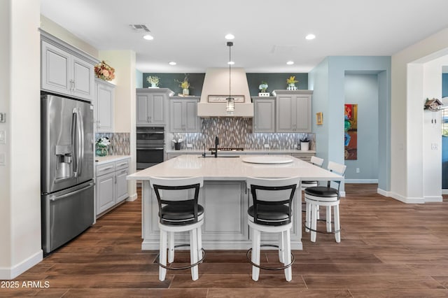 70 E Kennedia Dr, Queen Creek, AZ 85140 - kitchen featuring stainless steel appliances, custom exhaust hood, decorative backsplash, light countertops, and gray cabinetry
