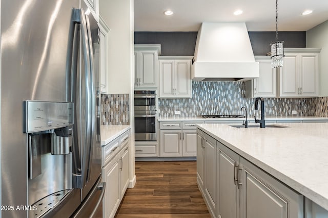 70 E Kennedia Dr, Queen Creek, AZ 85140 - kitchen featuring appliances with stainless steel finishes, custom range hood, dark wood finished floors, a sink, and pendant lighting