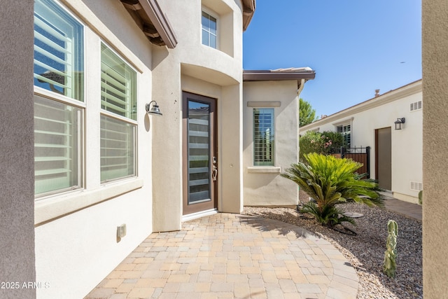 70 E Kennedia Dr, Queen Creek, AZ 85140 - doorway to property with stucco siding and a patio area
