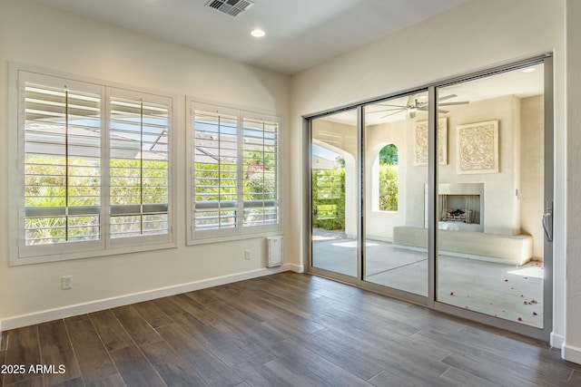 70 E Kennedia Dr, Queen Creek, AZ 85140 - doorway to outside with dark wood-type flooring, baseboards, ceiling fan, recessed lighting, and a fireplace with raised hearth