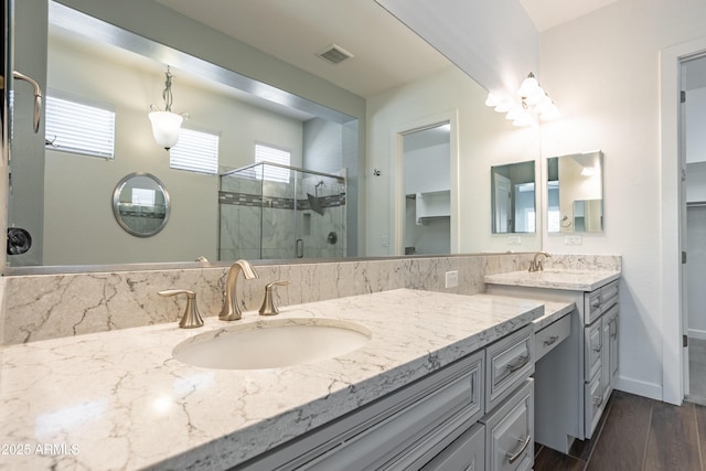 70 E Kennedia Dr, Queen Creek, AZ 85140 - full bathroom featuring double vanity, a shower stall, wood finished floors, and baseboards