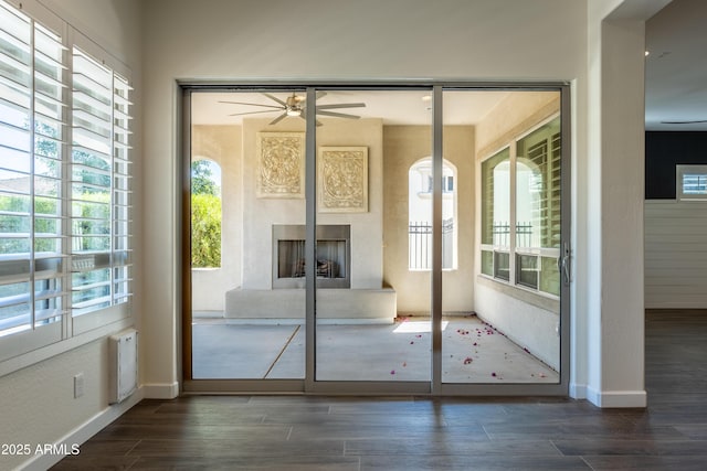 70 E Kennedia Dr, Queen Creek, AZ 85140 - doorway featuring wood finished floors, a ceiling fan, baseboards, and a fireplace with raised hearth