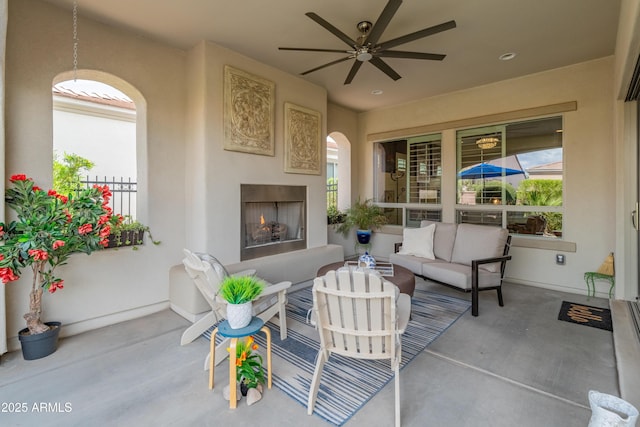 70 E Kennedia Dr, Queen Creek, AZ 85140 - view of patio / terrace with an outdoor living space with a fireplace and a ceiling fan