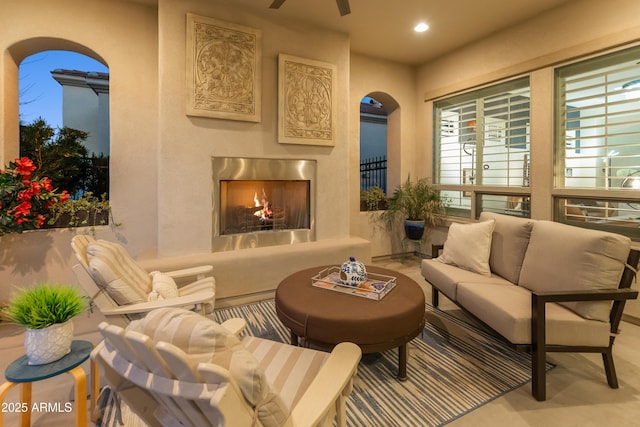 70 E Kennedia Dr, Queen Creek, AZ 85140 - living area with arched walkways, a premium fireplace, recessed lighting, and ceiling fan