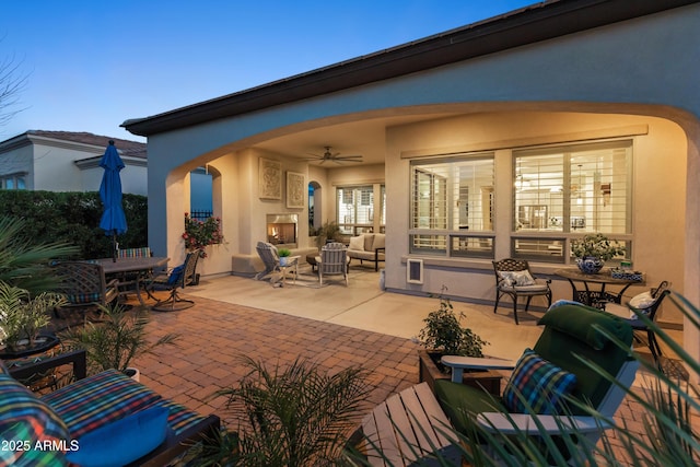 70 E Kennedia Dr, Queen Creek, AZ 85140 - view of patio / terrace with an outdoor living space with a fireplace, a ceiling fan, and outdoor dining space