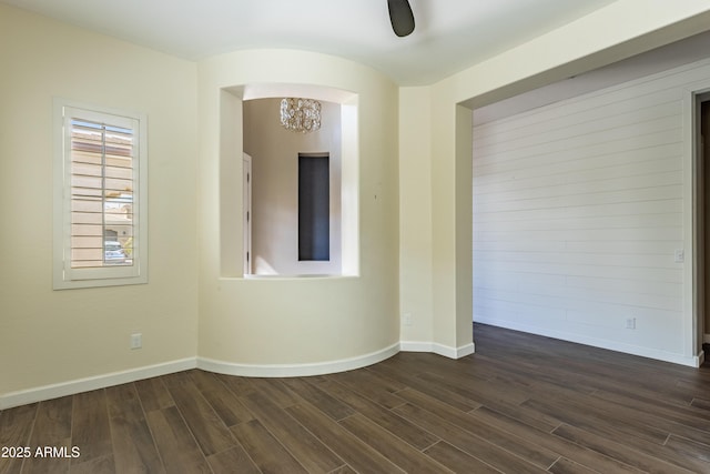 70 E Kennedia Dr, Queen Creek, AZ 85140 - empty room with dark wood finished floors, a chandelier, baseboards, and arched walkways