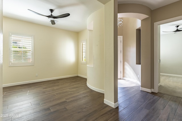 70 E Kennedia Dr, Queen Creek, AZ 85140 - spare room with ceiling fan, dark wood-style flooring, arched walkways, and baseboards