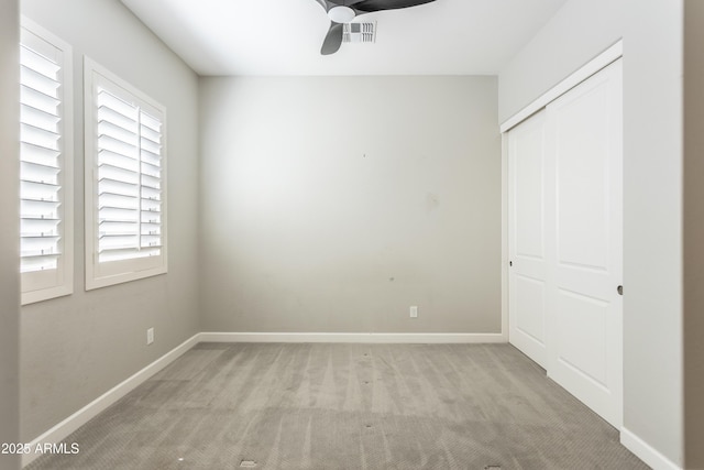 70 E Kennedia Dr, Queen Creek, AZ 85140 - unfurnished bedroom featuring light carpet, a closet, baseboards, and a ceiling fan