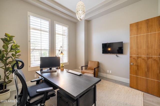 home office featuring wood finished floors and baseboards