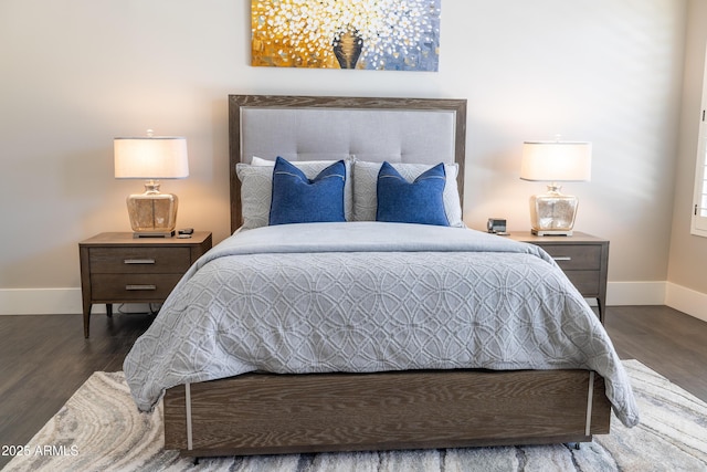 bedroom featuring wood finished floors and baseboards