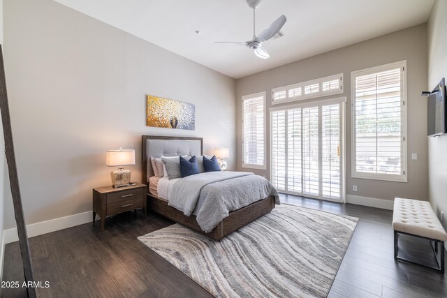 bedroom featuring access to exterior, multiple windows, dark wood-type flooring, and baseboards