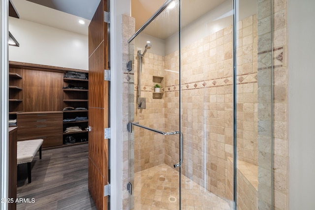 full bathroom with wood finished floors and a shower stall