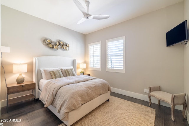 bedroom with dark wood-type flooring, baseboards, and ceiling fan