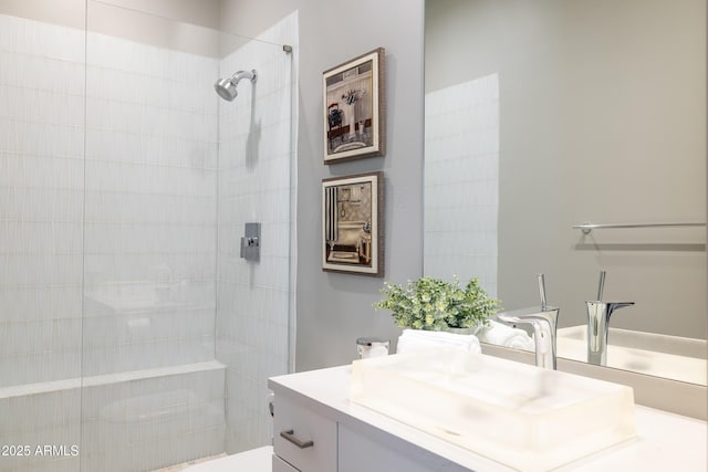 bathroom with vanity and tiled shower