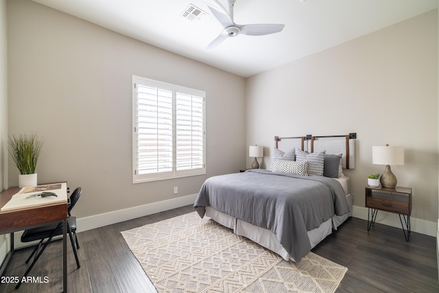 bedroom with a ceiling fan, wood finished floors, visible vents, and baseboards