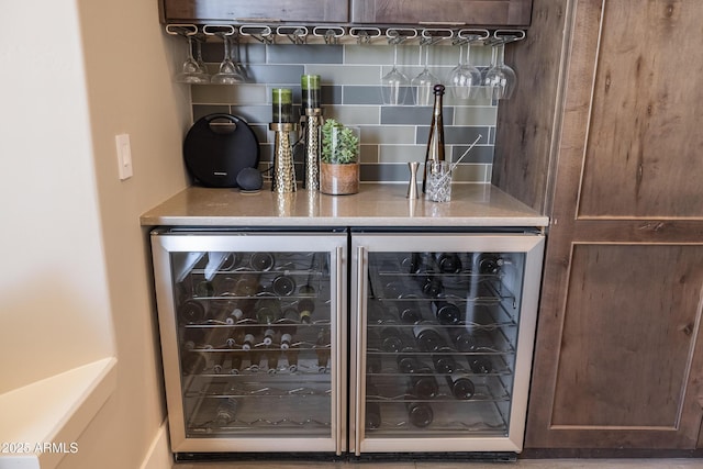 bar with tasteful backsplash, wine cooler, and a dry bar