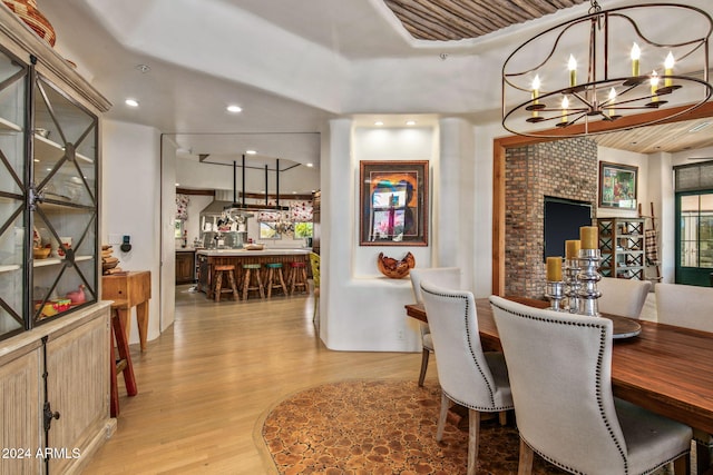 dining room with an inviting chandelier and light wood-type flooring