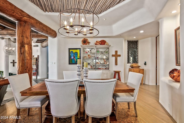 dining room with a notable chandelier and light hardwood / wood-style flooring