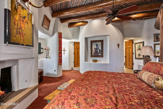 carpeted bedroom with a towering ceiling, beamed ceiling, and wooden ceiling