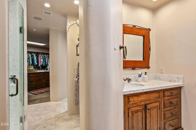 bathroom with vanity and an enclosed shower