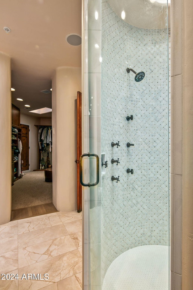 bathroom with walk in shower and wood-type flooring