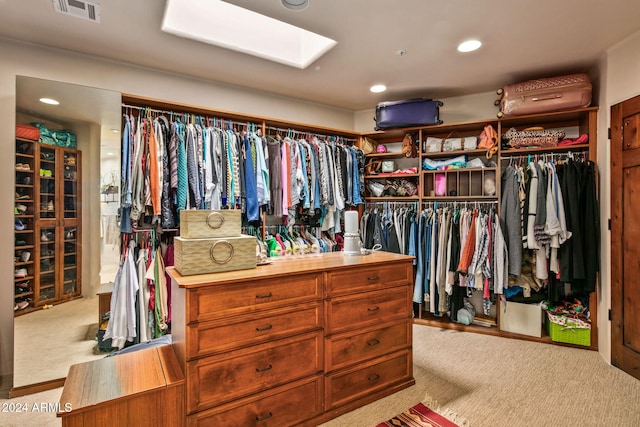 walk in closet featuring light colored carpet