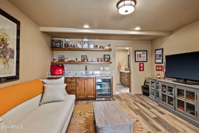 bar featuring light hardwood / wood-style floors and wine cooler