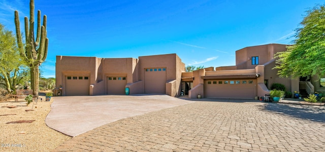 pueblo-style home featuring a garage