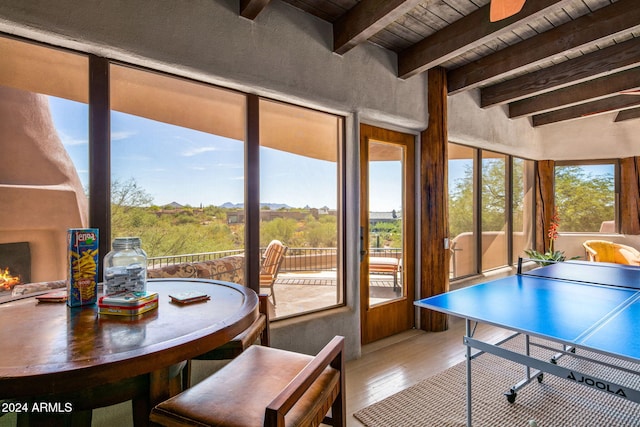 sunroom featuring wood ceiling and beam ceiling