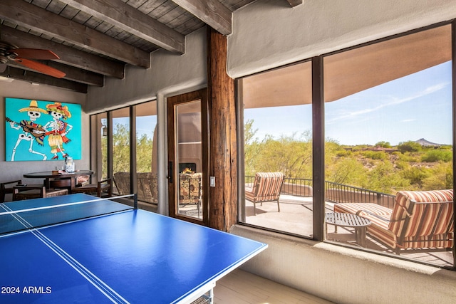 rec room with ceiling fan, wooden ceiling, and beam ceiling